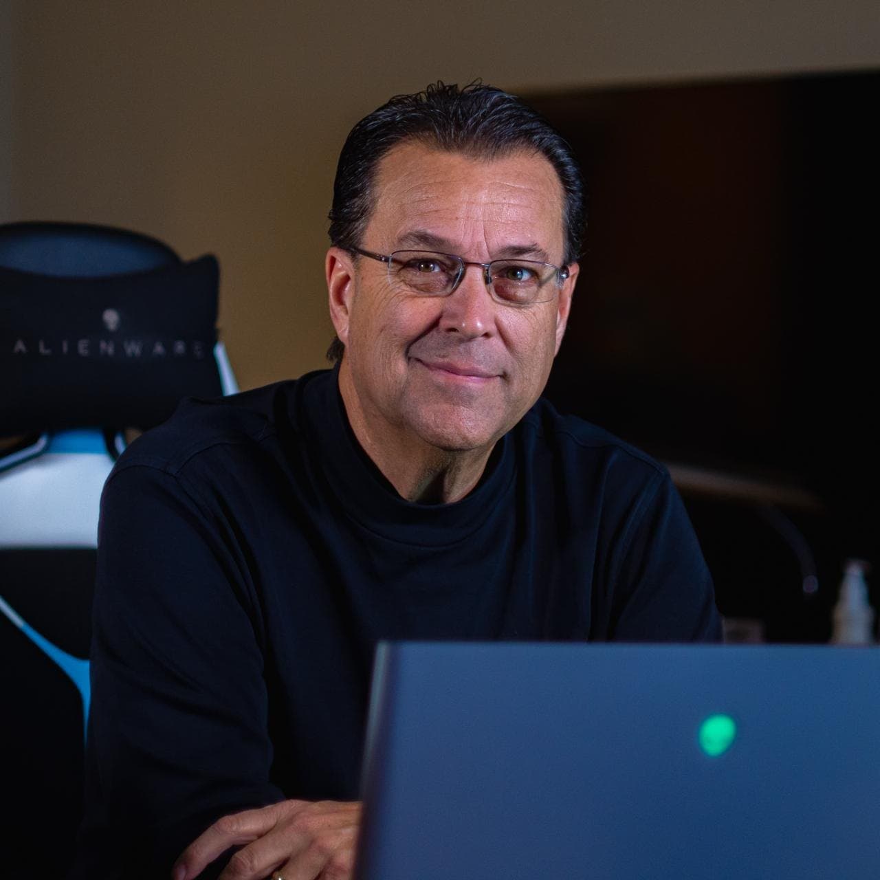 Mike Rasmussen, CPA, co-founder of REVREX, at his office desk